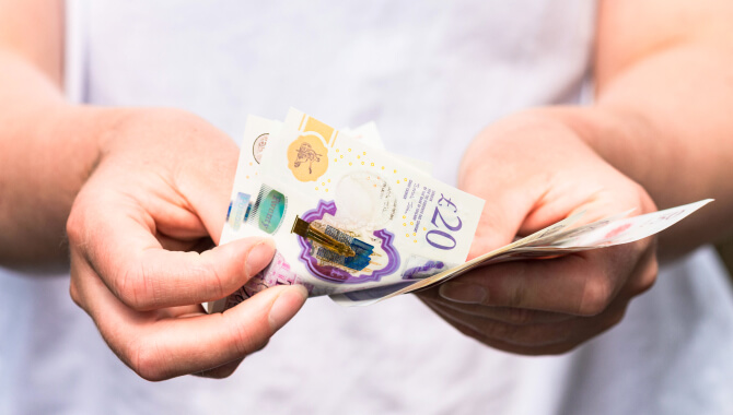 Person holding 20 pound notes
